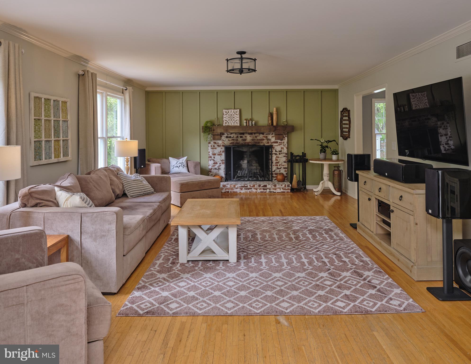 71 Big Spring Road Califon, NJ 07830 - Photo 11 of 41 a living room with furniture a flat screen tv and a fireplace