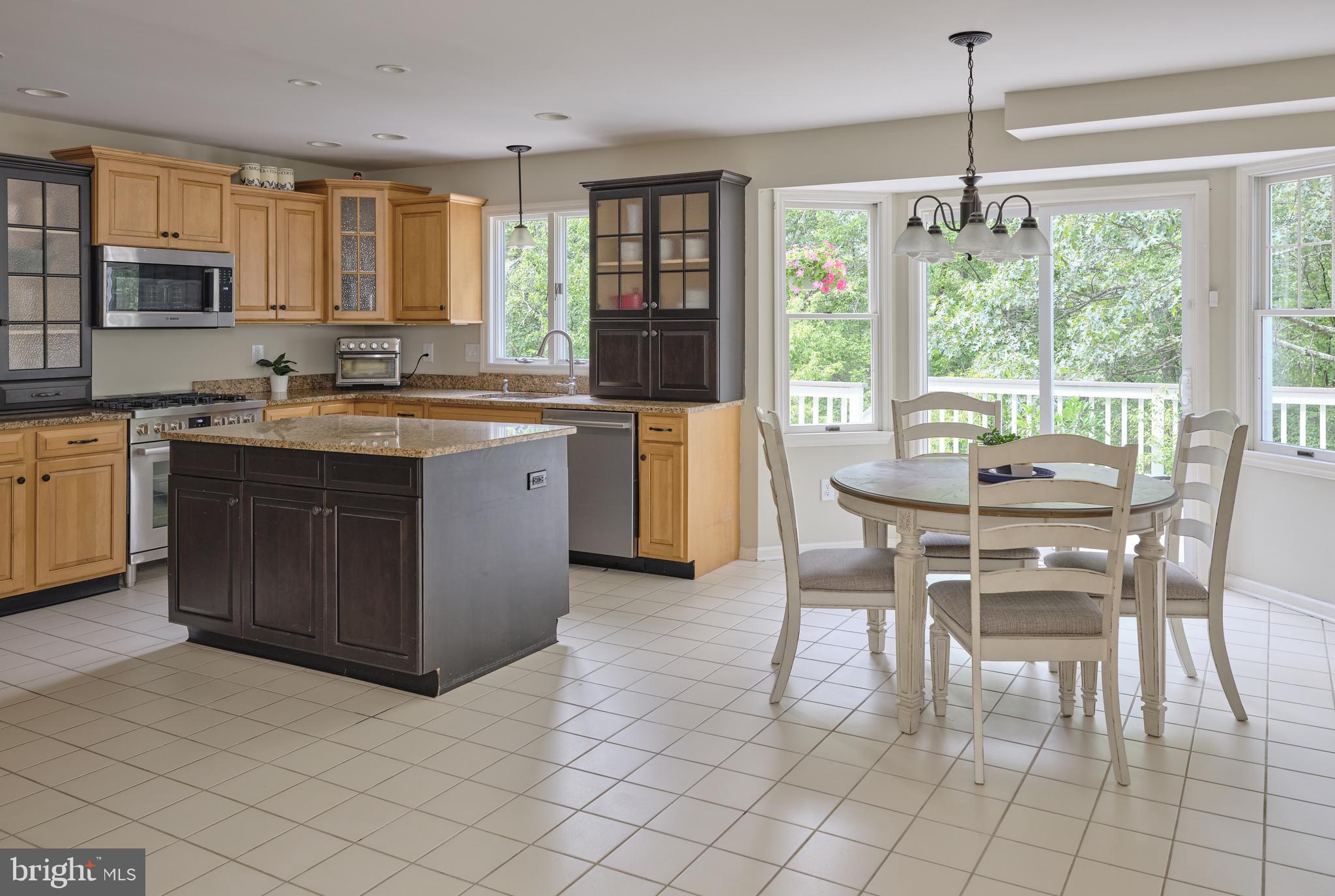 71 Big Spring Road Califon, NJ 07830 - Photo 12 of 41 a kitchen with a dining table chairs and white cabinets