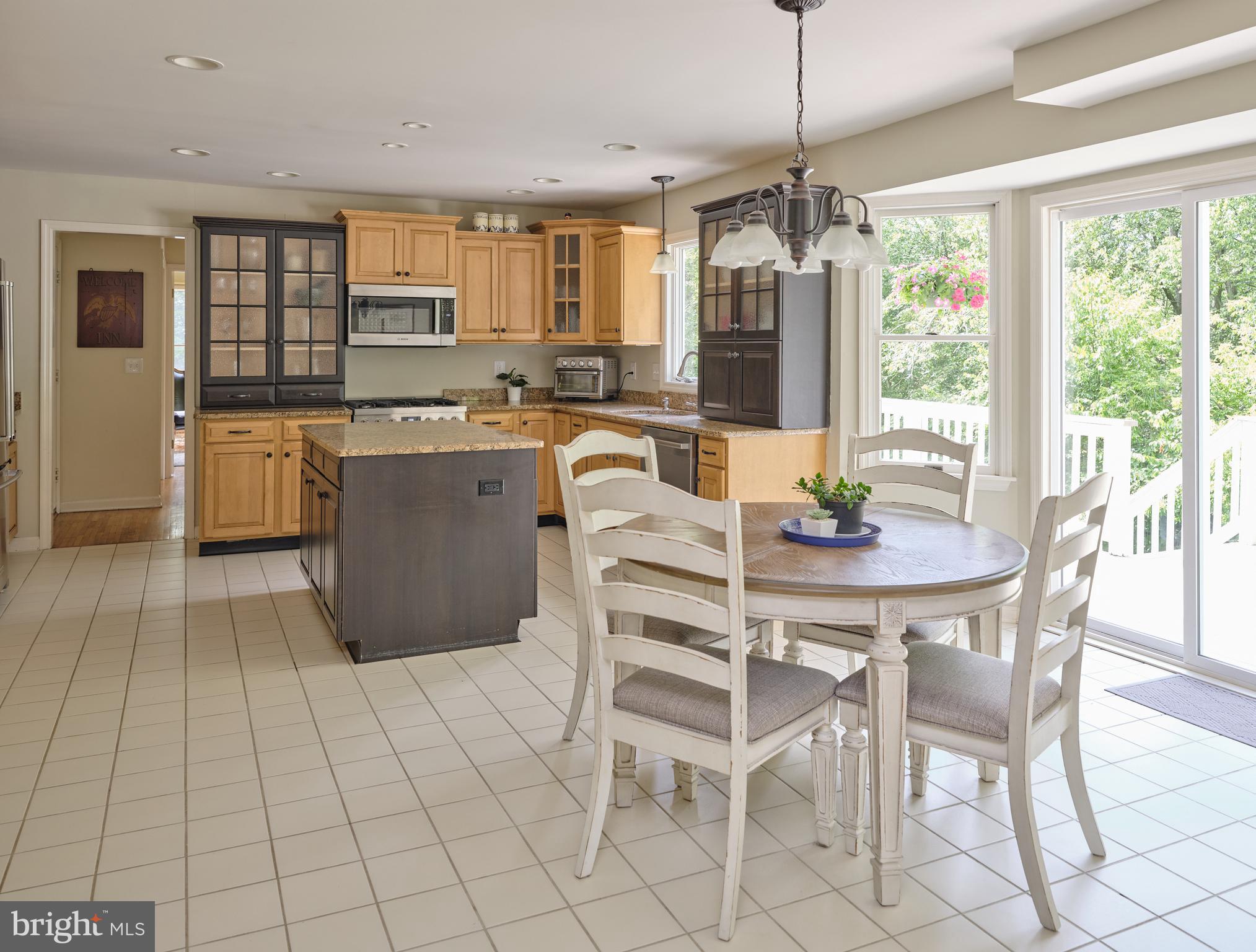 71 Big Spring Road Califon, NJ 07830 - Photo 10 of 41 a kitchen with stainless steel appliances granite countertop a stove a sink a microwave dining table and chairs