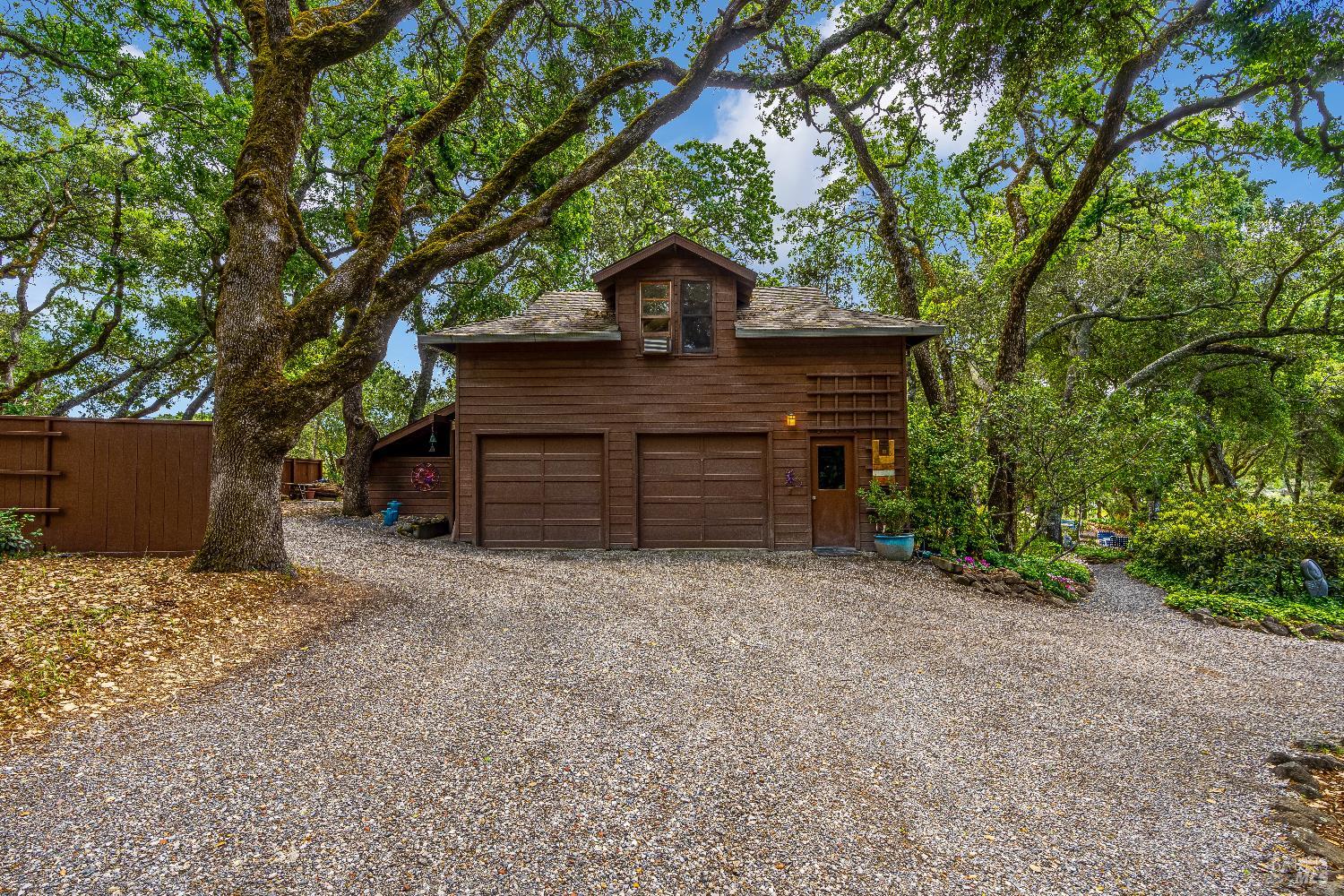 10601 Slattery Road Glen Ellen, CA 95442 - Photo 33 of 45 A portion of circular driveway shown; detached garage with shop area and studio above.