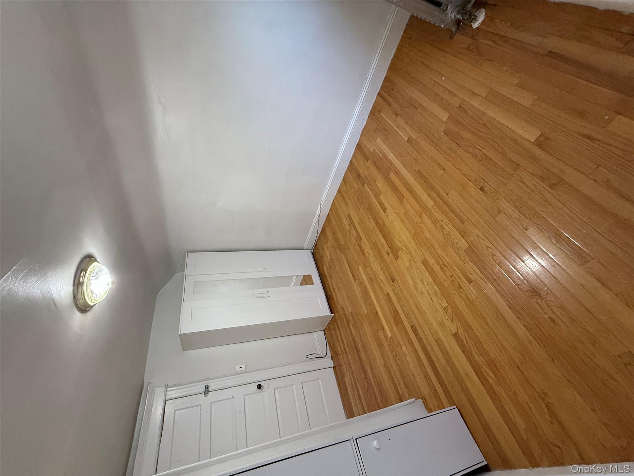 92-40 53rd Avenue, Unit 3 Queens, NY 11373 - Photo 3 of 8 a view of empty room with wooden floor