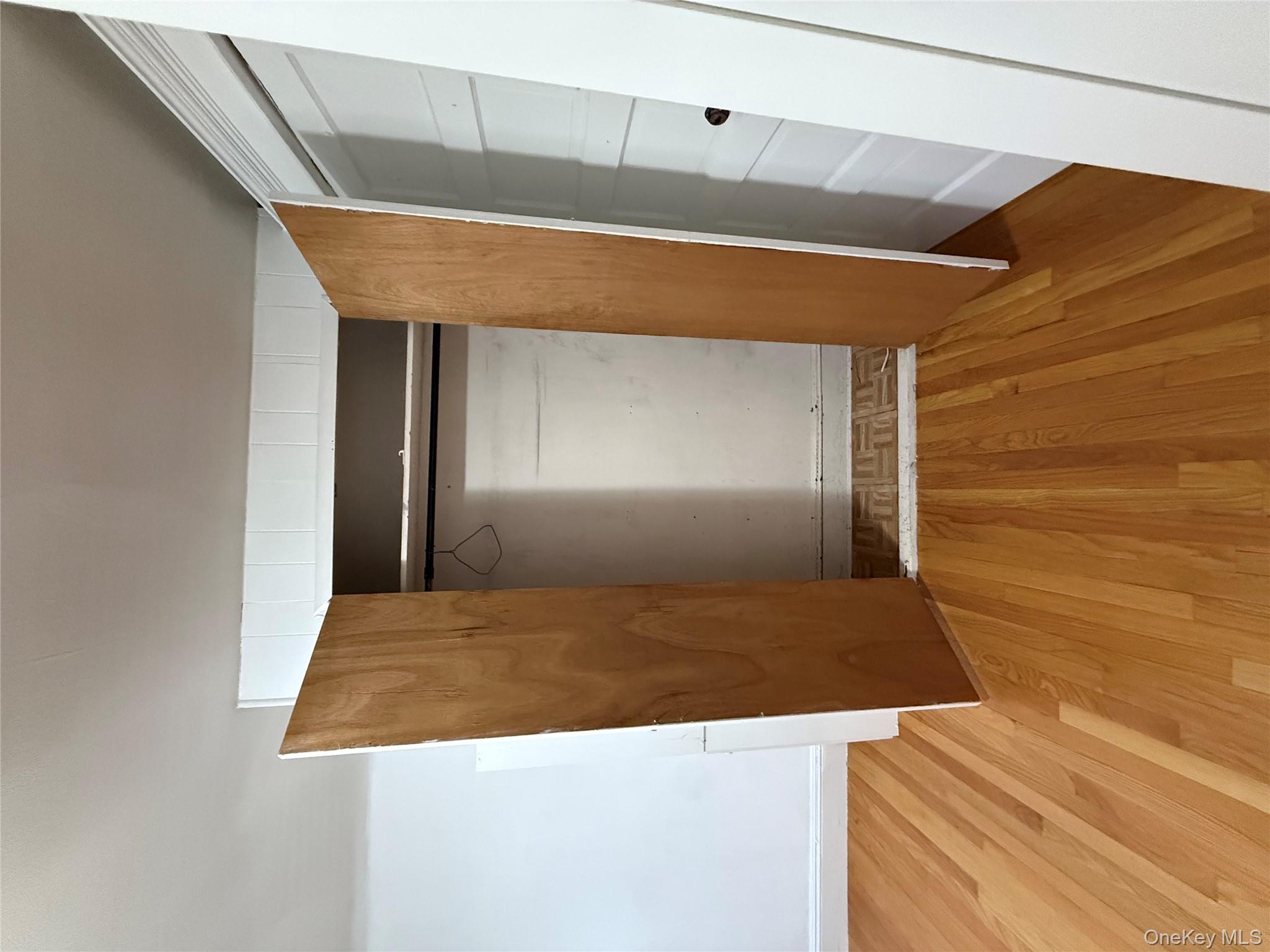 92-40 53rd Avenue, Unit 3 Queens, NY 11373 - Photo 5 of 8 a view of an empty room with wooden floor and a window
