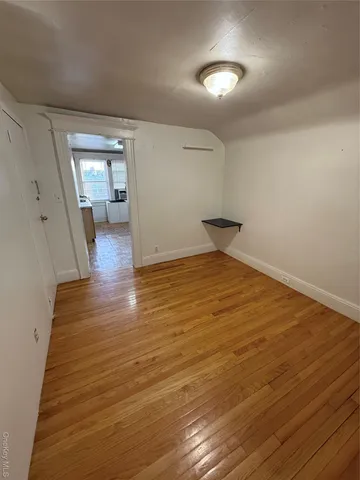 a view of a room with wooden floor