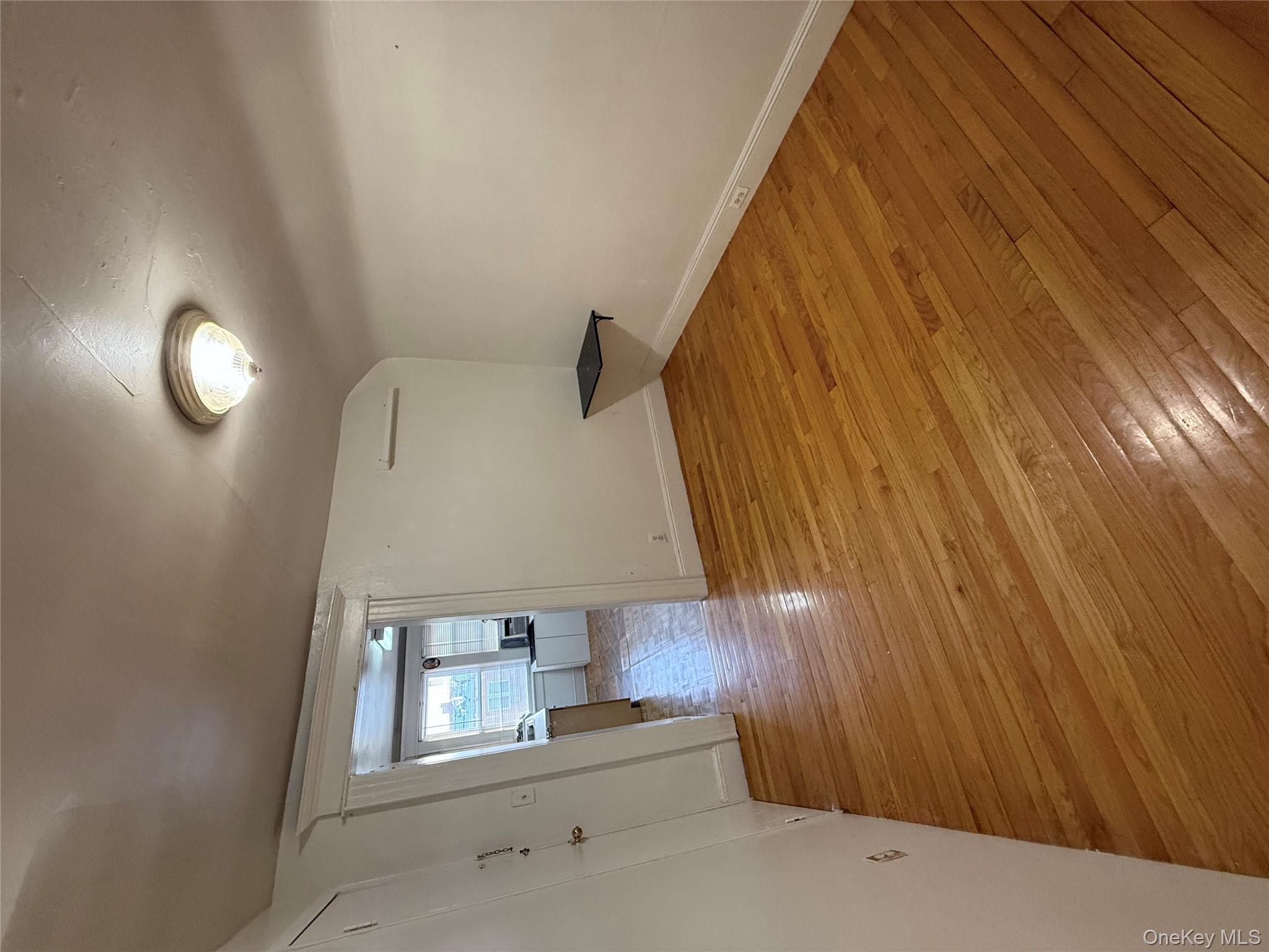 92-40 53rd Avenue, Unit 3 Queens, NY 11373 - Photo 6 of 8 a view of a room with wooden floor