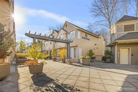 a view of a patio with couches table and chairs and potted plants