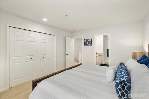 a bedroom with a bed and a painting on the wall