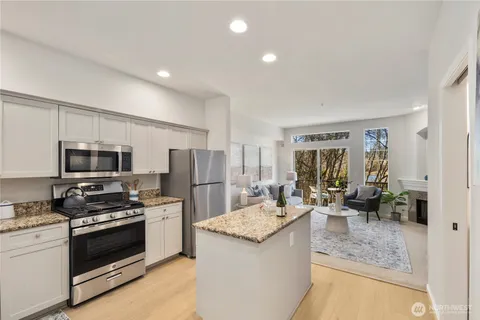 a kitchen with stainless steel appliances a stove a sink and a refrigerator