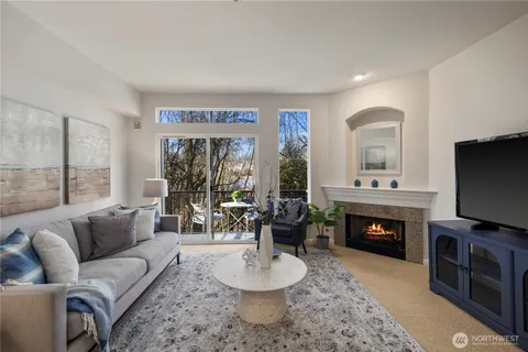 a living room with fireplace furniture and a flat screen tv