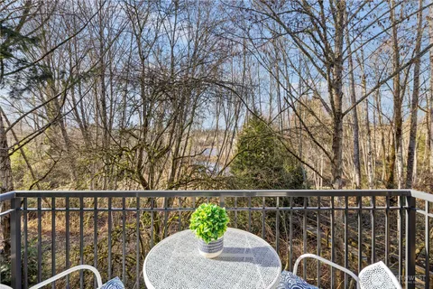 a view of a balcony with two chairs