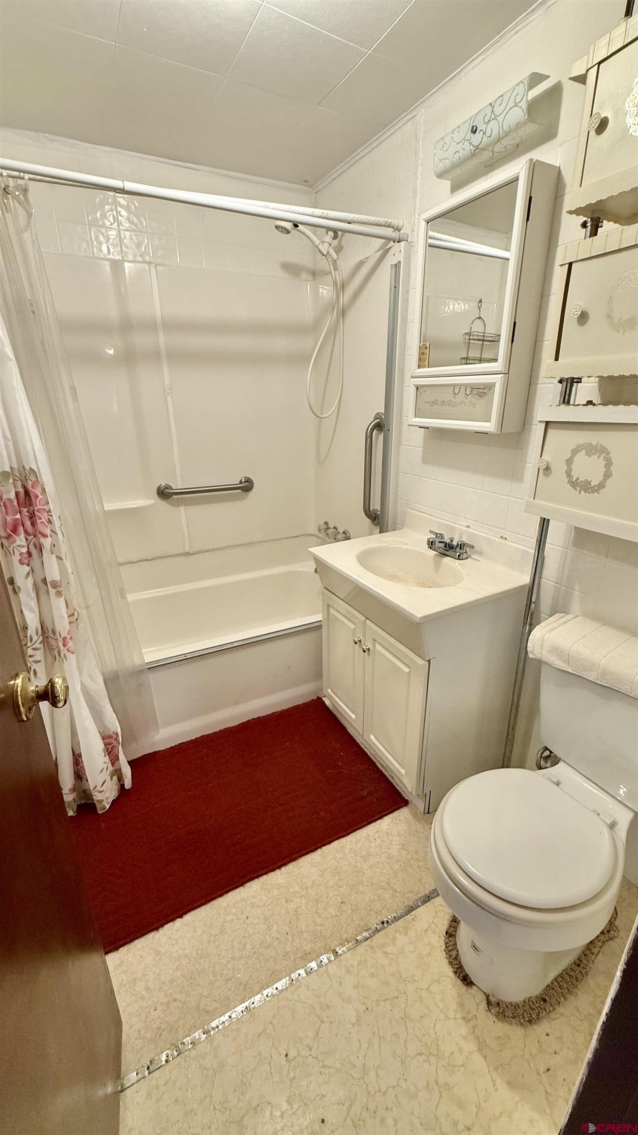 1704 Ross Avenue Alamosa, CO 81101 - Photo 16 of 28 a bathroom with a sink a toilet and a shower