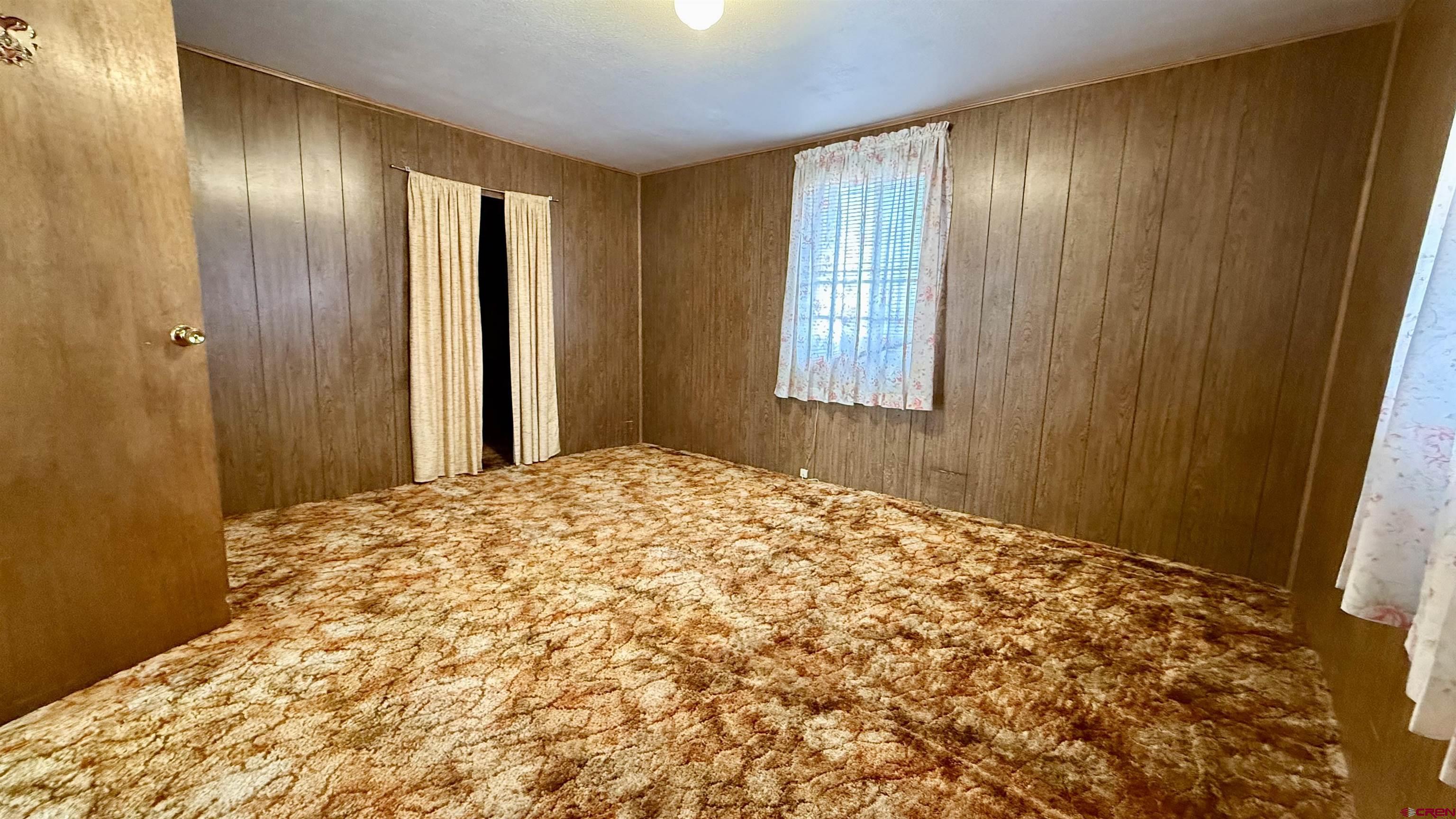 1704 Ross Avenue Alamosa, CO 81101 - Photo 24 of 28 a bedroom with a bed and a window