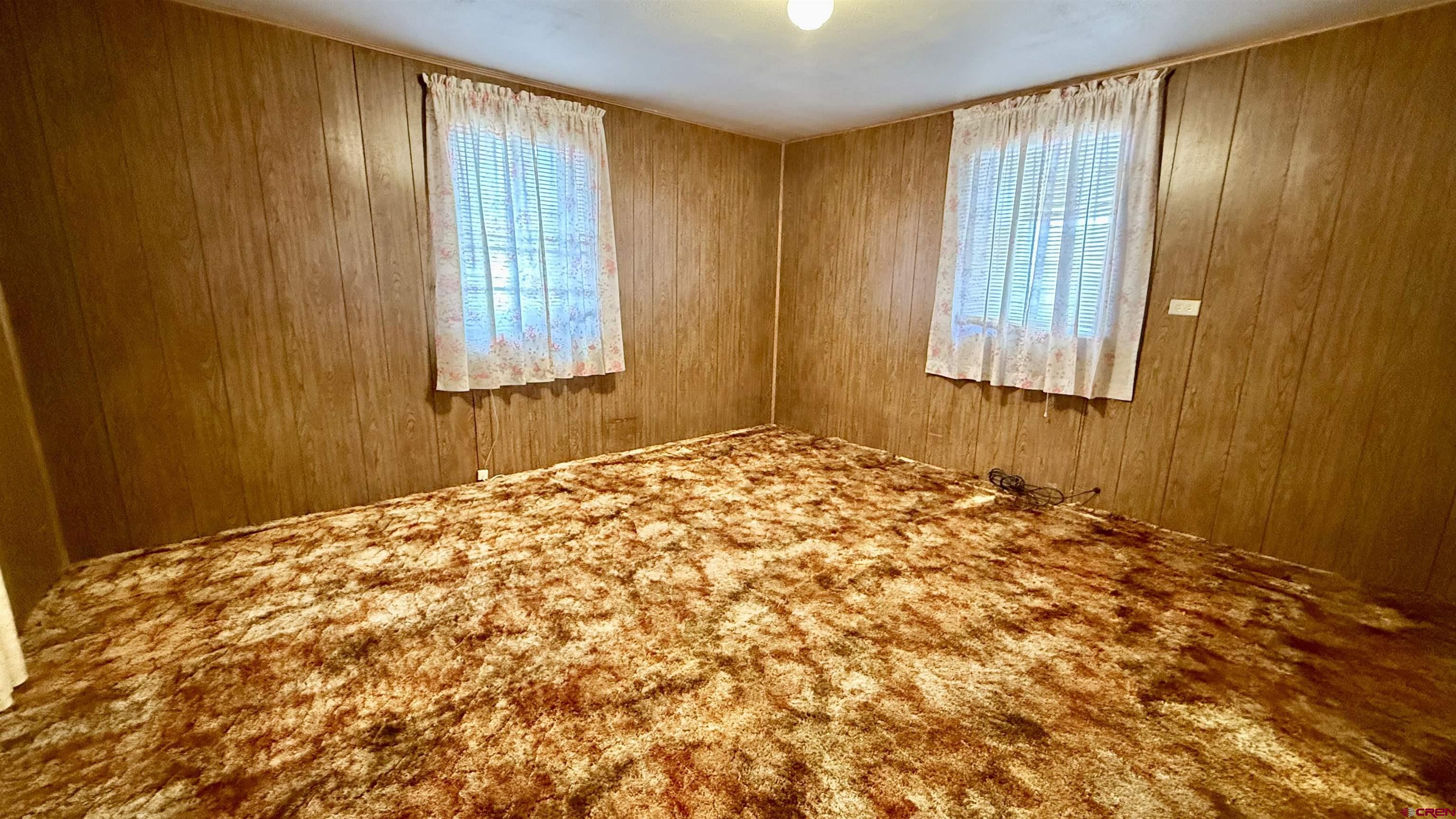 1704 Ross Avenue Alamosa, CO 81101 - Photo 25 of 28 a bedroom with a bed and a window