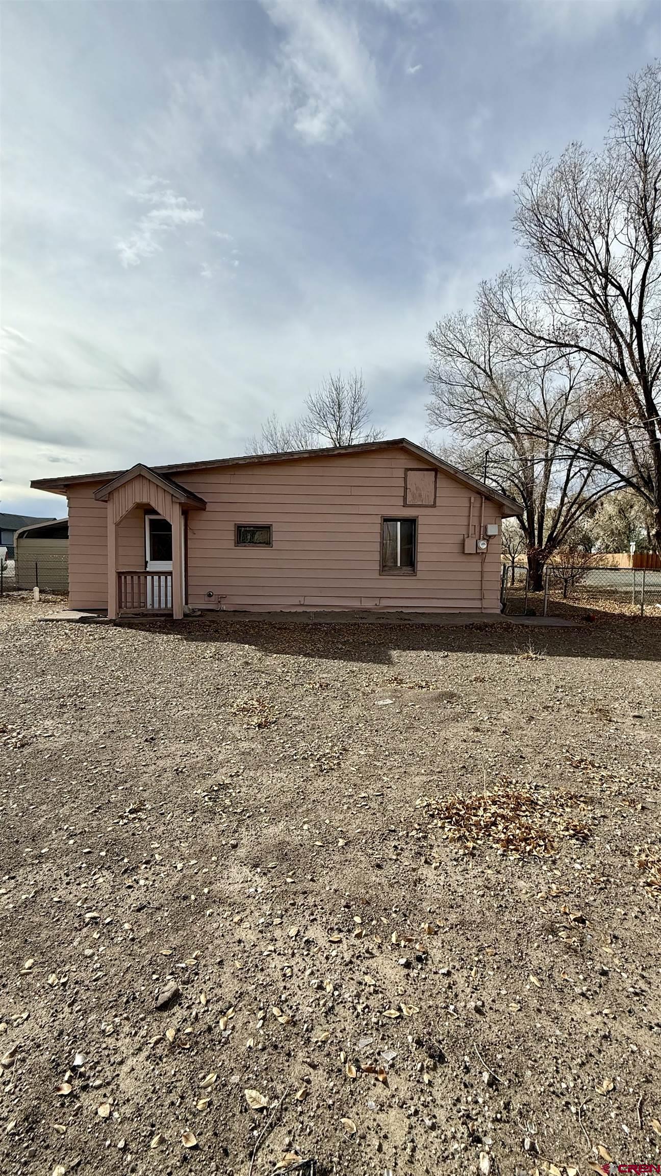 1704 Ross Avenue Alamosa, CO 81101 - Photo 4 of 28 a house view with wooden fence