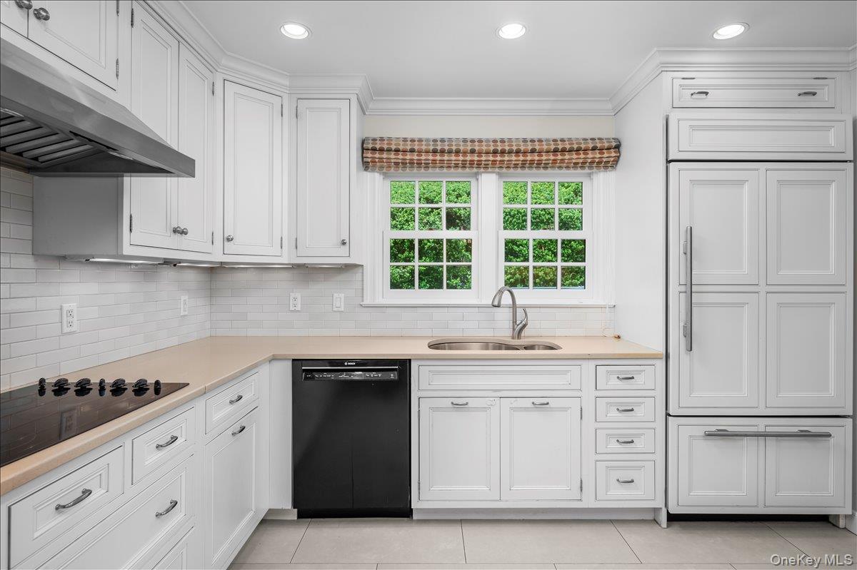 49 Eton Road Larchmont, NY 10538 - Photo 13 of 34 a kitchen with white cabinets and a stove