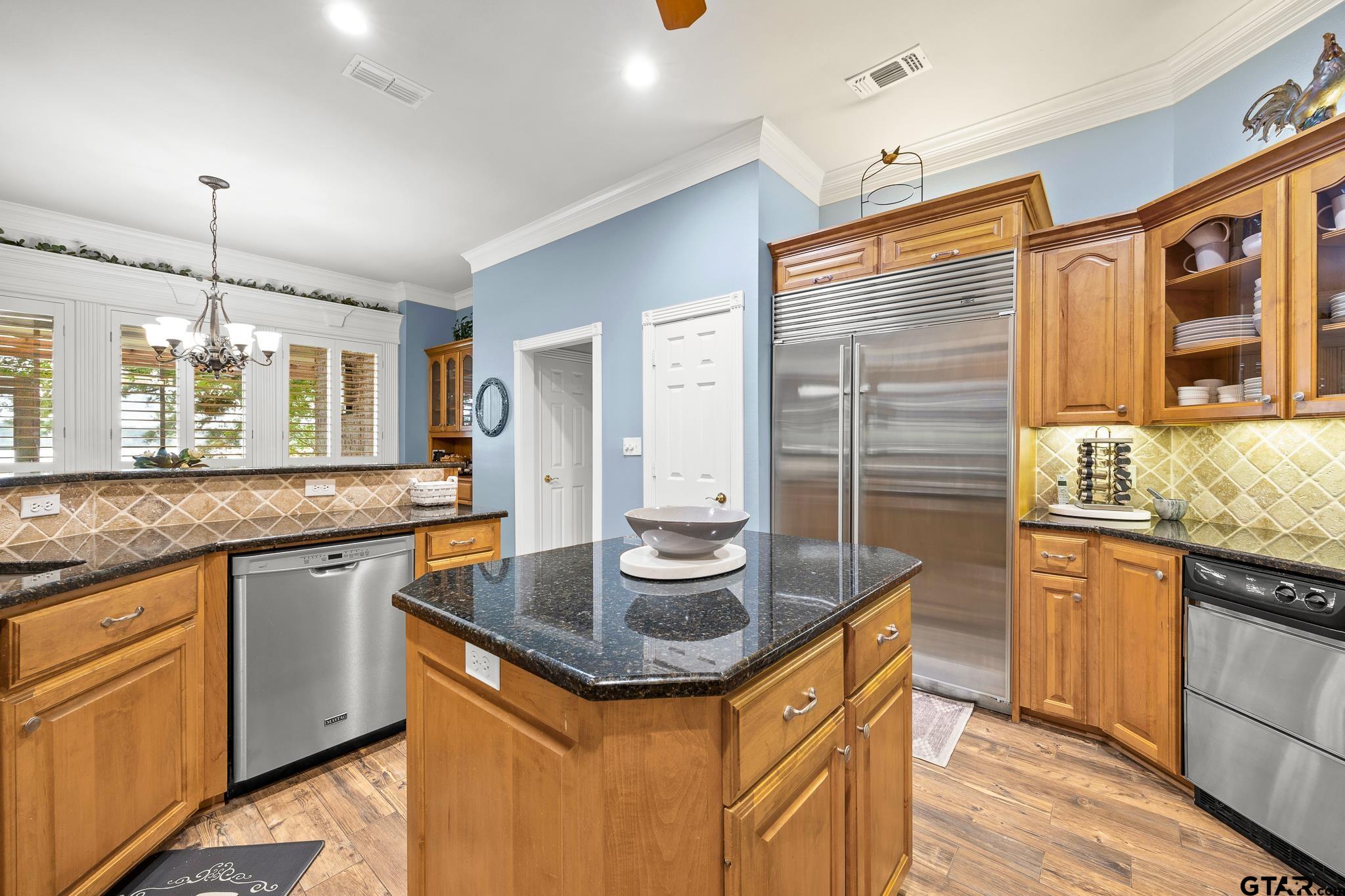 15198 East Ridge Road Arp, TX 75750 - Photo 12 of 48 a kitchen with granite countertop kitchen island stainless steel appliances a sink stove and cabinets