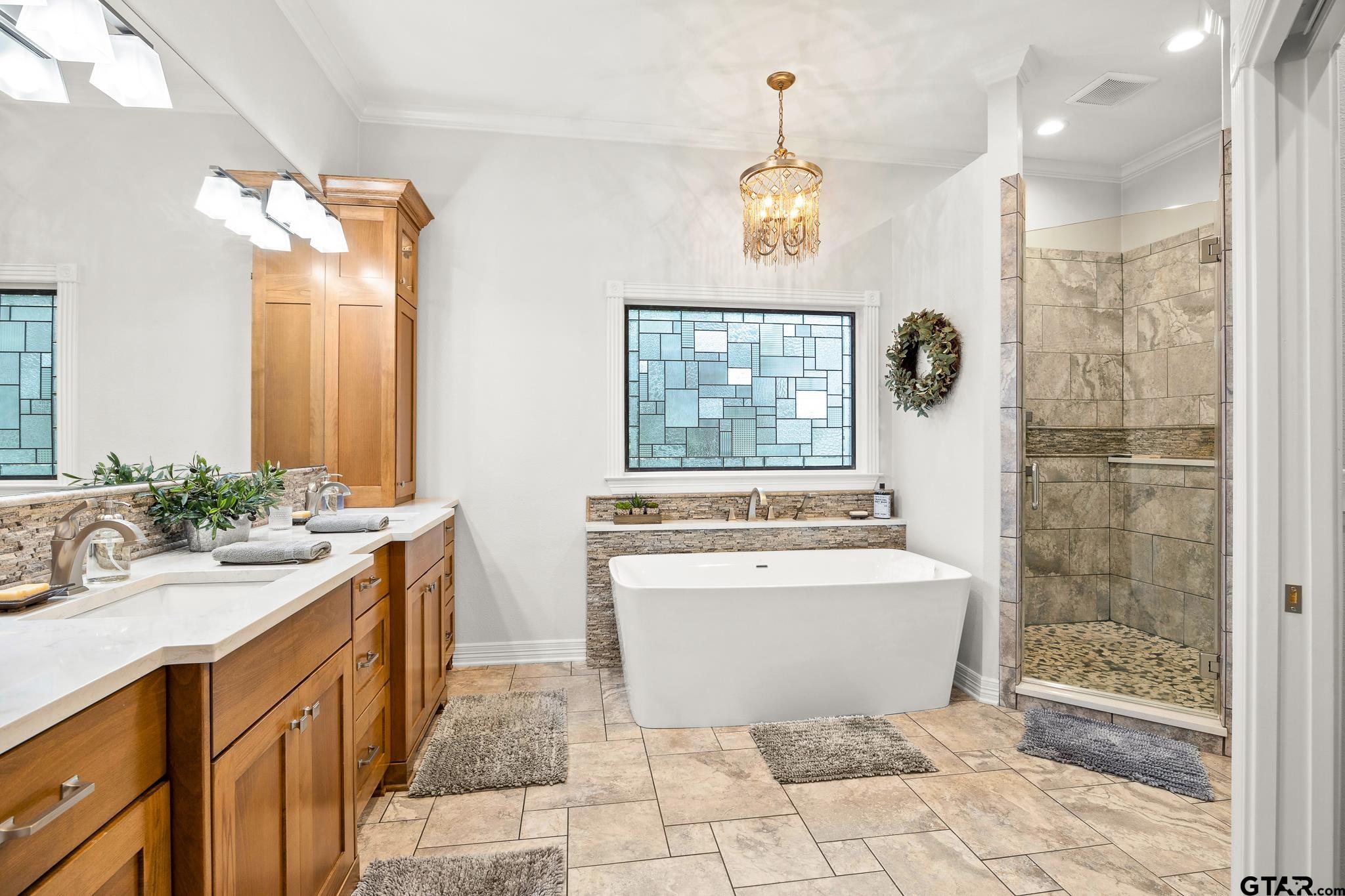 15198 East Ridge Road Arp, TX 75750 - Photo 23 of 48 a spacious bathroom with a sink a mirror a bathtub and a shower