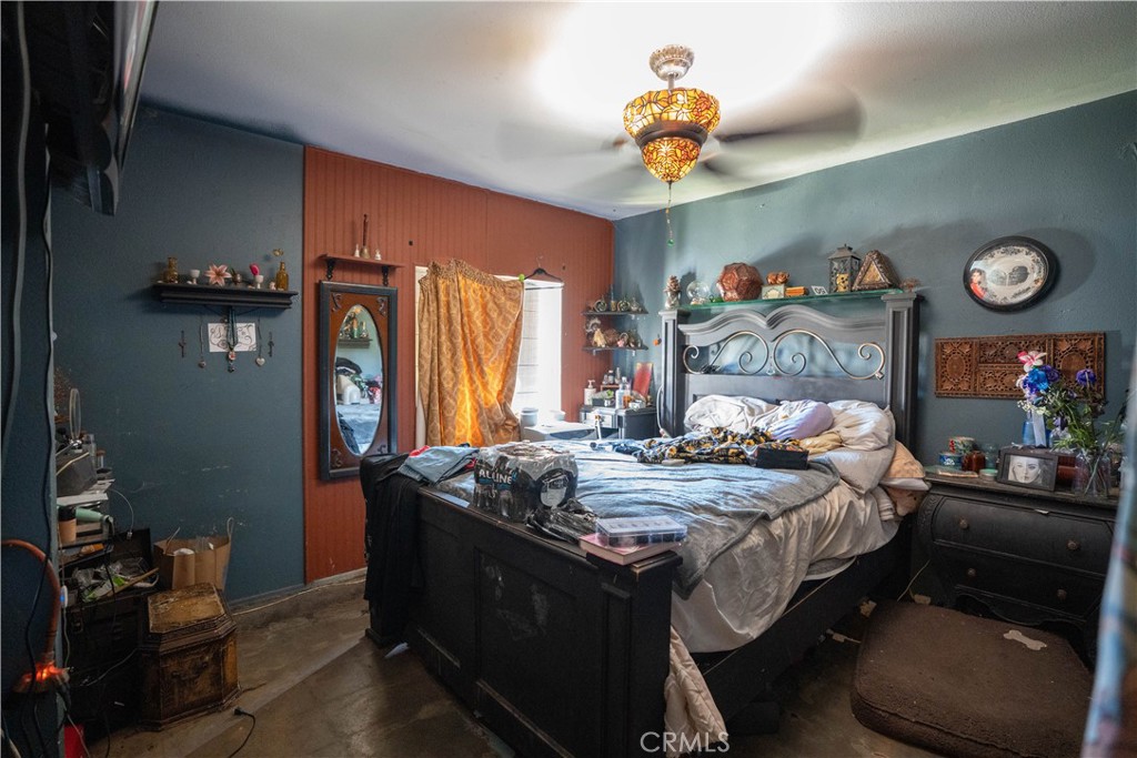6174 Jurupa Avenue Riverside, CA 92504 - Photo 23 of 30 a bedroom with a bed and a chandelier