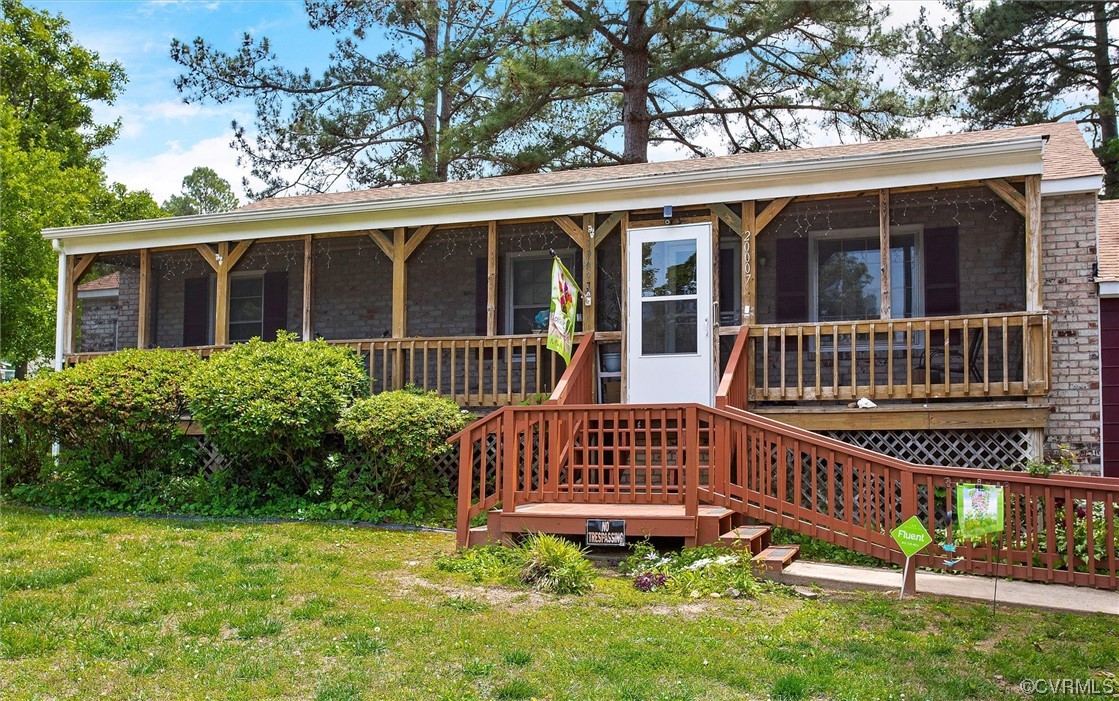 20007 Eugene Drive Sutherland, VA 23885 - Photo 3 of 21 a view of a house with a deck and a yard