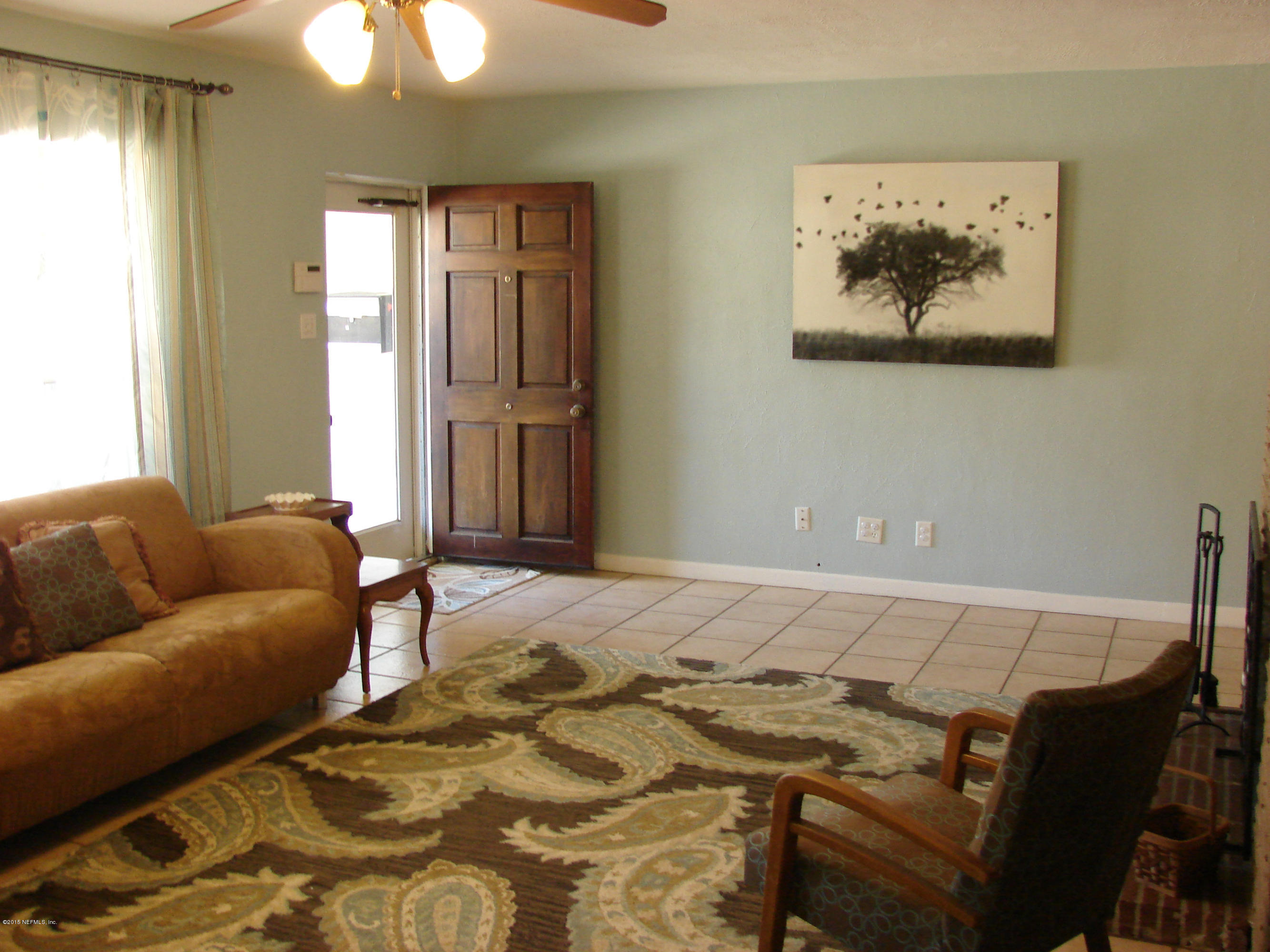 6301 Colgate Road Jacksonville, FL 32217 - Photo 2 of 24 a bedroom with a bed and a chandelier