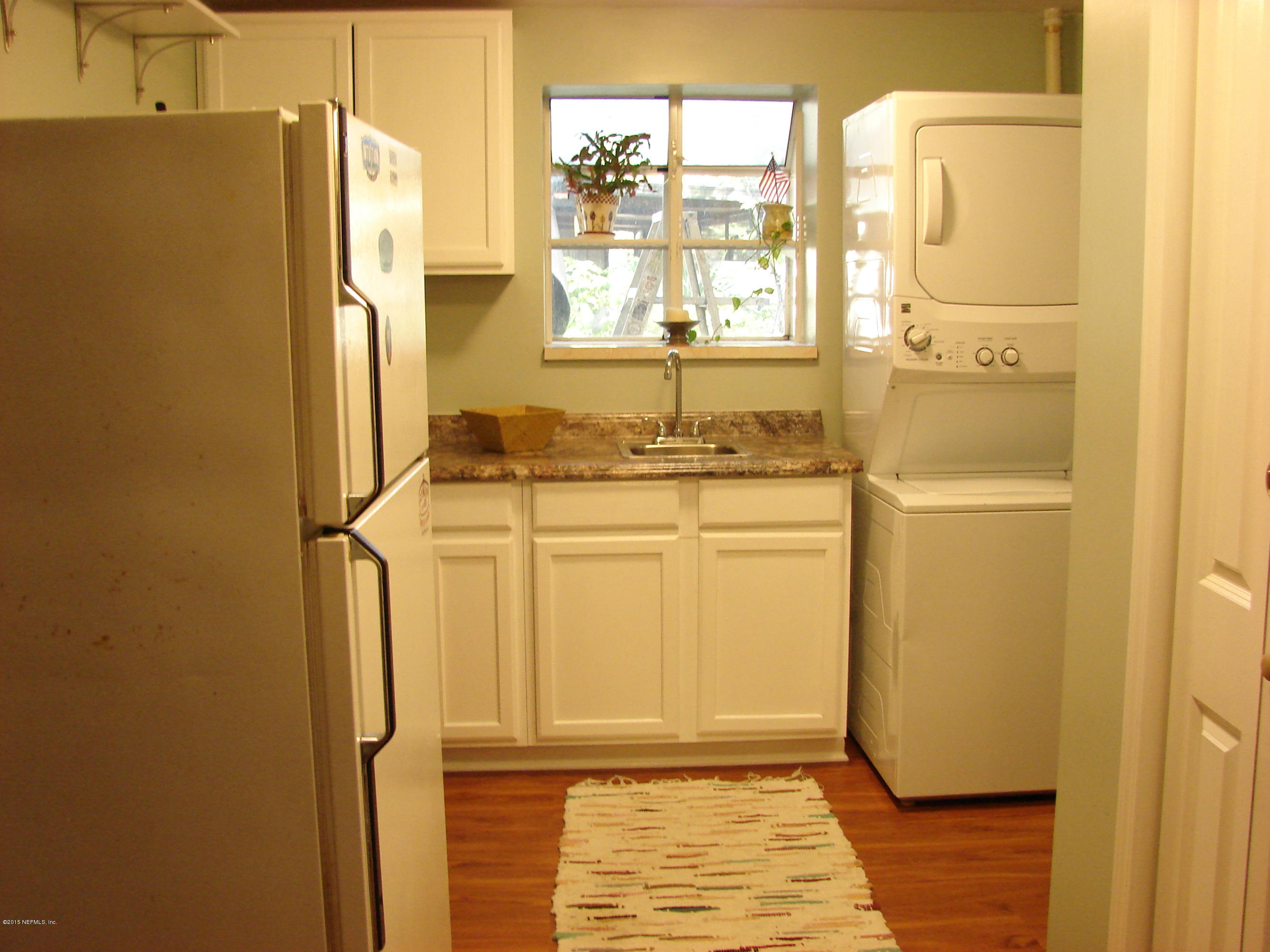 6301 Colgate Road Jacksonville, FL 32217 - Photo 3 of 24 a bathroom with a refrigerator and window