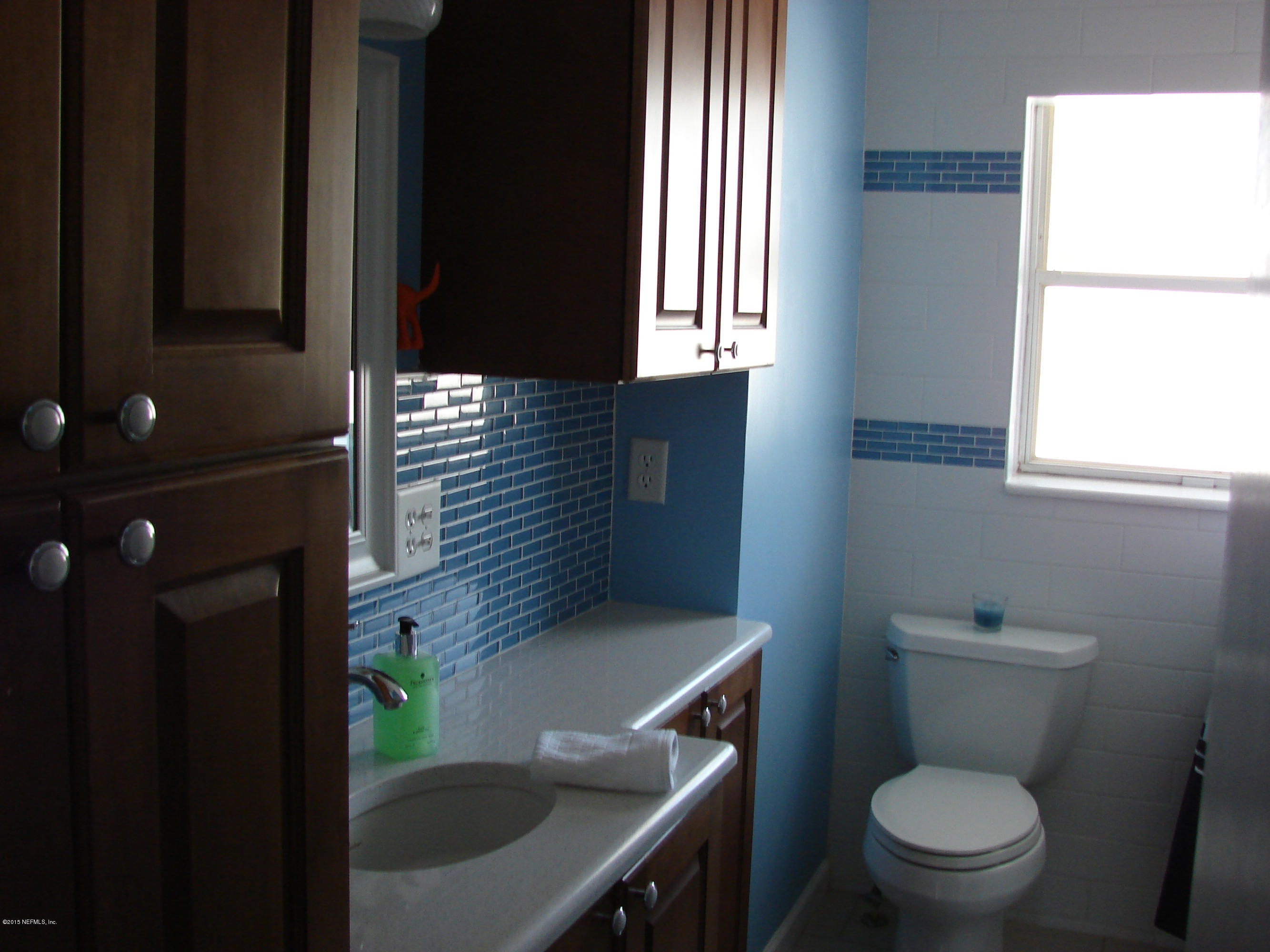 6301 Colgate Road Jacksonville, FL 32217 - Photo 5 of 24 a bathroom with a toilet sink and mirror