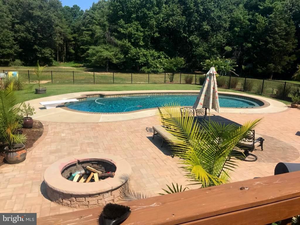 19095 Ridge Road Colonial Beach, VA 22443 - Photo 19 of 57 Alt view of pool with back yard and woods beyond.