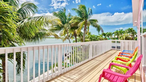 a balcony with wooden floor and fence