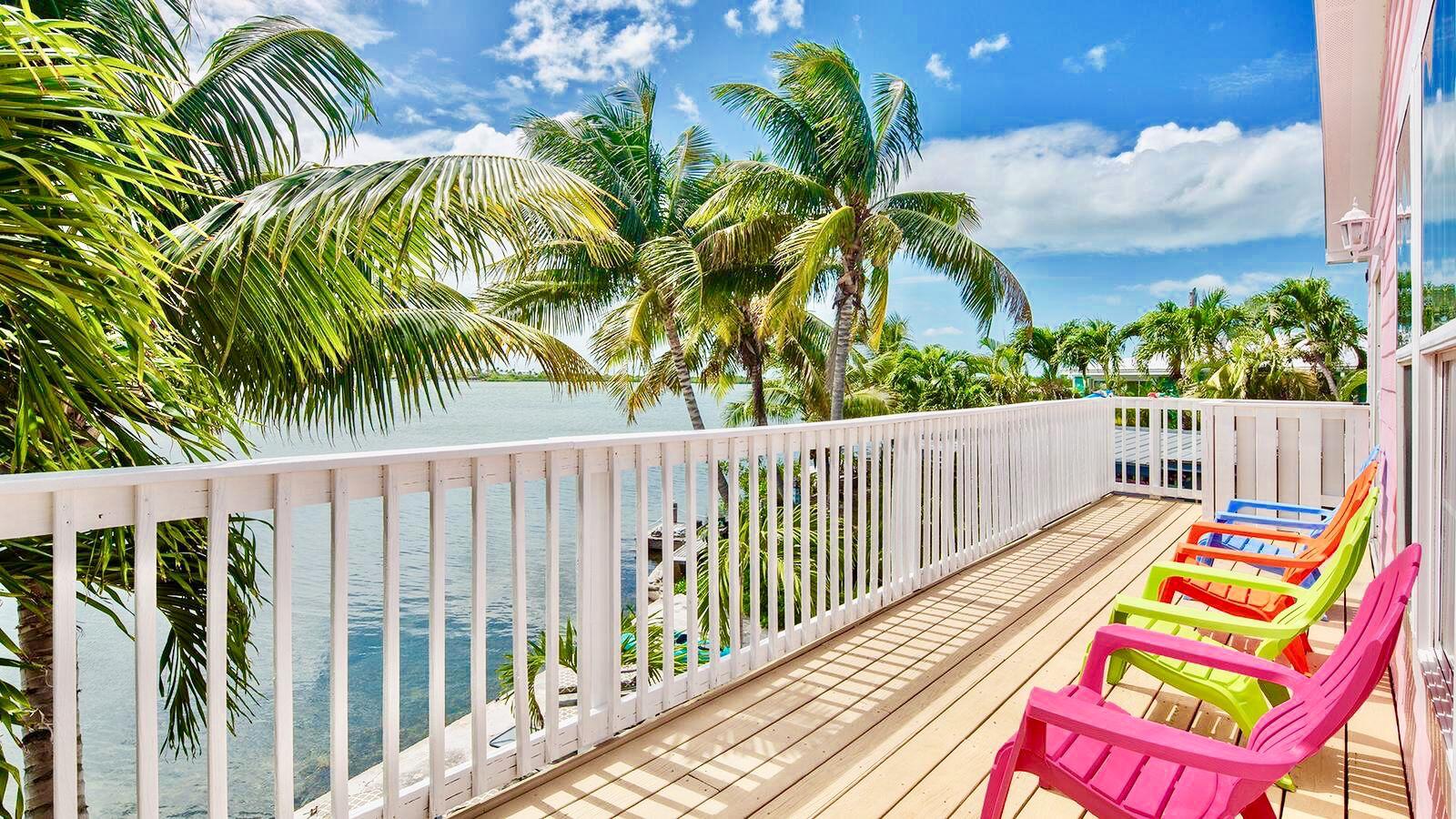 32 Beach Drive Key West, FL 33040 - Photo 1 of 33 a balcony with wooden floor and fence