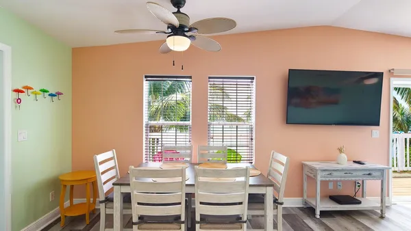 a view of a livingroom with furniture and a flat screen tv