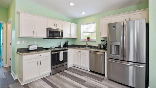 a kitchen with a refrigerator stove and sink