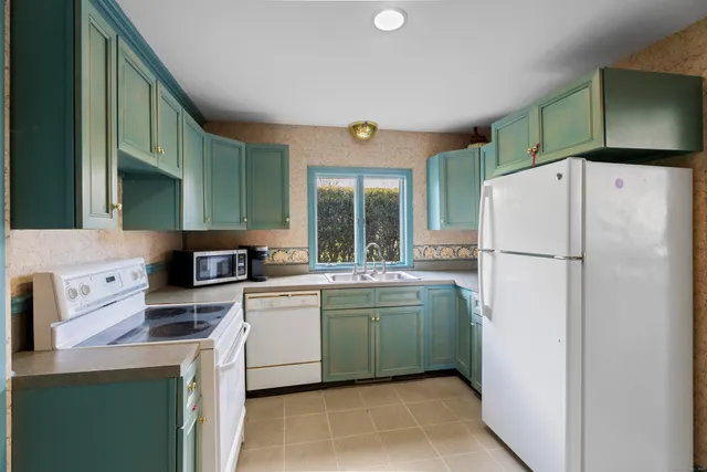 a kitchen with a refrigerator and a sink
