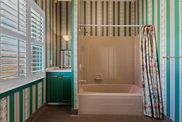 a bathroom with a bathtub and a shower