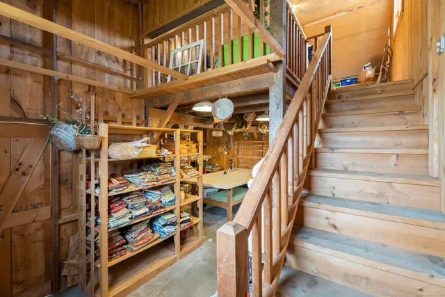 a view of a living room with clothes and shoes
