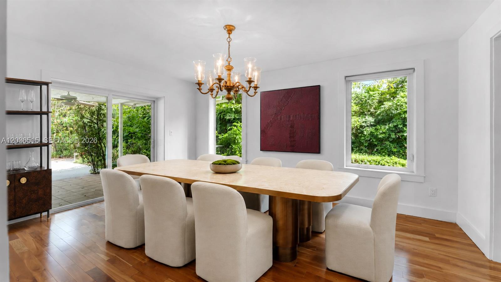 7711 Erwin Road Coral Gables, FL 33143 - Photo 7 of 26 a dining room with furniture a chandelier and wooden floor