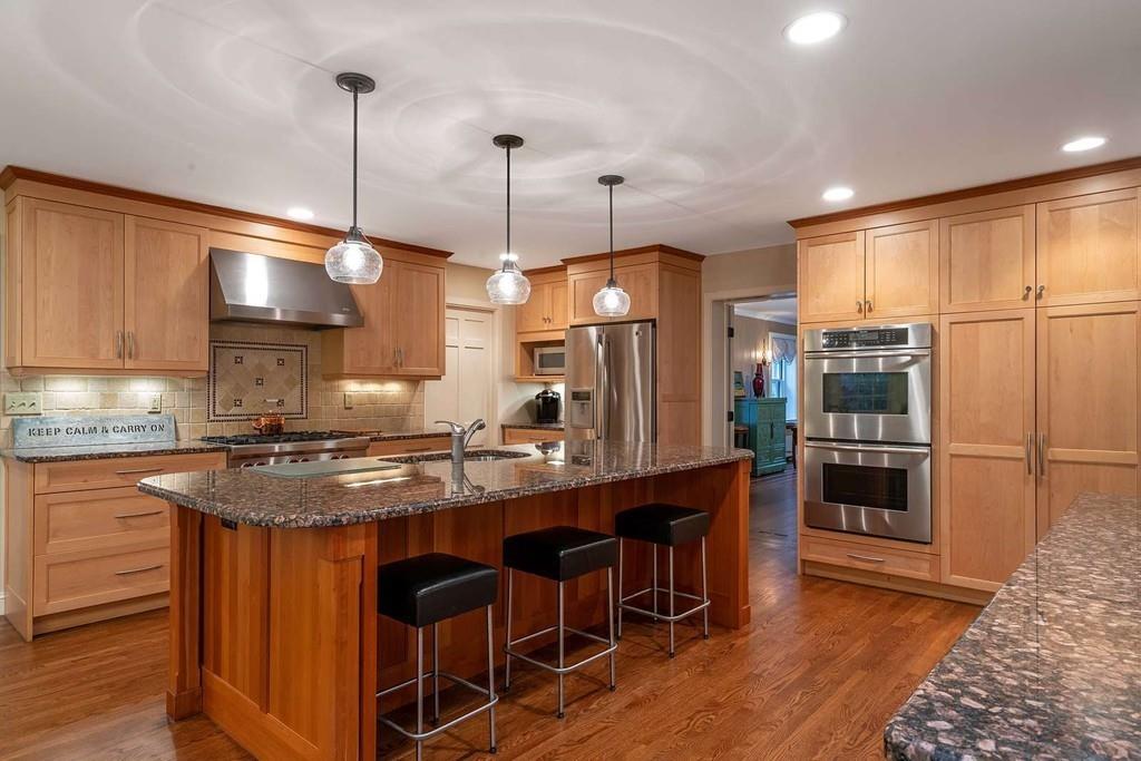 80 Audubon Road Wellesley, MA 02481 - Photo 5 of 33 a kitchen with stainless steel appliances granite countertop a stove and refrigerator