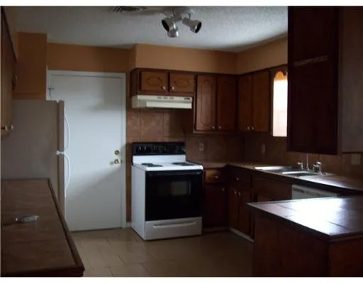 a kitchen with a sink and a refrigerator