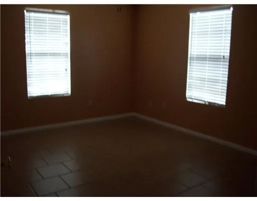 a view of a small space with wooden floor and a window