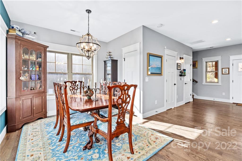 5 Feather Ridge Drive Asheville, NC 28805 - Photo 13 of 32 a dining room with furniture a chandelier and wooden floor