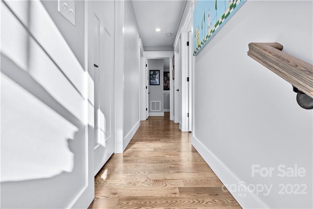 5 Feather Ridge Drive Asheville, NC 28805 - Photo 16 of 32 a view of a hallway with wooden floor and staircase