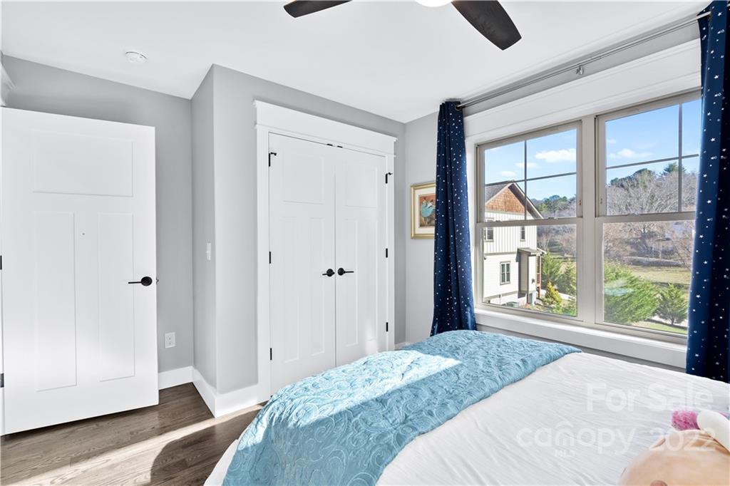 5 Feather Ridge Drive Asheville, NC 28805 - Photo 22 of 32 a bedroom with a bed and large window with outer view