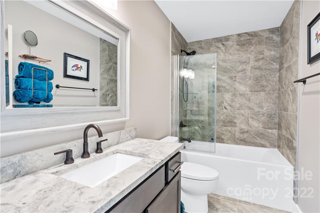 5 Feather Ridge Drive Asheville, NC 28805 - Photo 23 of 32 a bathroom with a granite countertop sink toilet and shower
