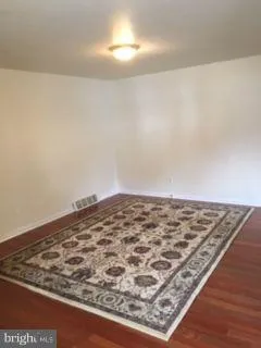 a view of an empty room and wooden floor