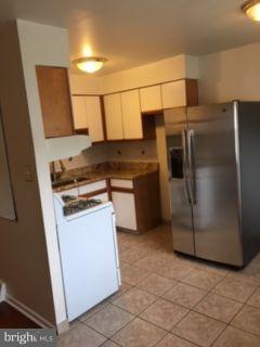 82 3rd Avenue Broomall, PA 19008 - Photo 7 of 17 a kitchen with stainless steel appliances granite countertop a refrigerator a stove and a sink