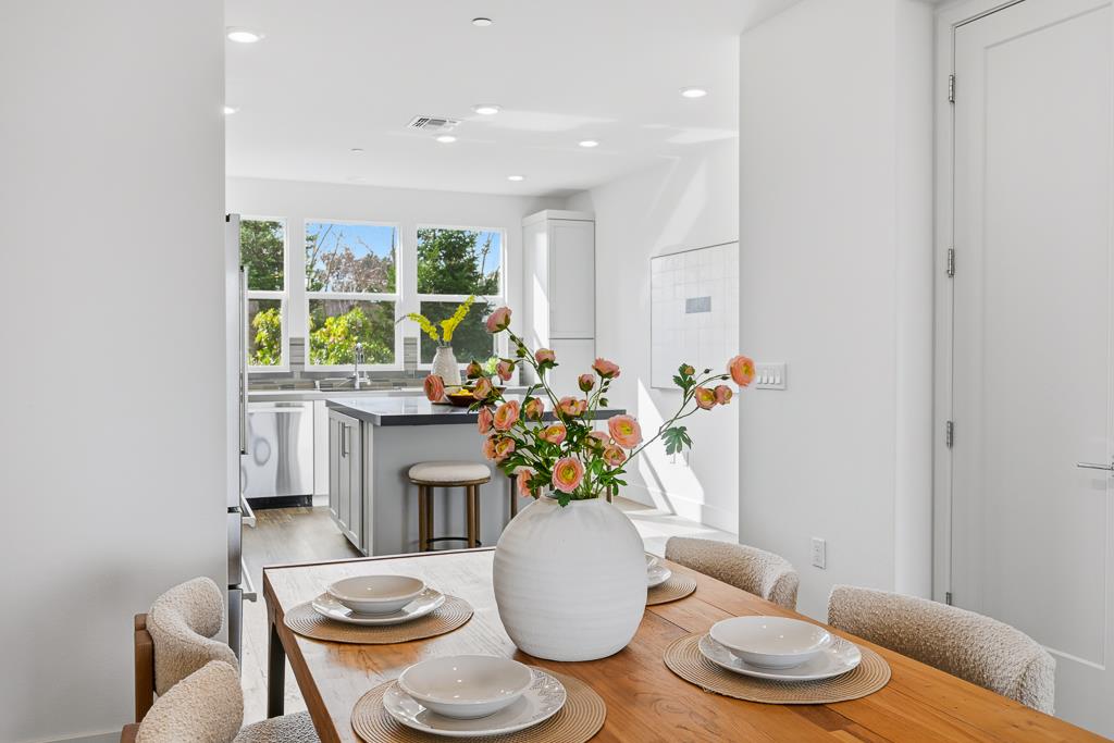 2287 Mora Place Mountain View, CA 94040 - Photo 11 of 64 a dining room with furniture a rug and a potted plant