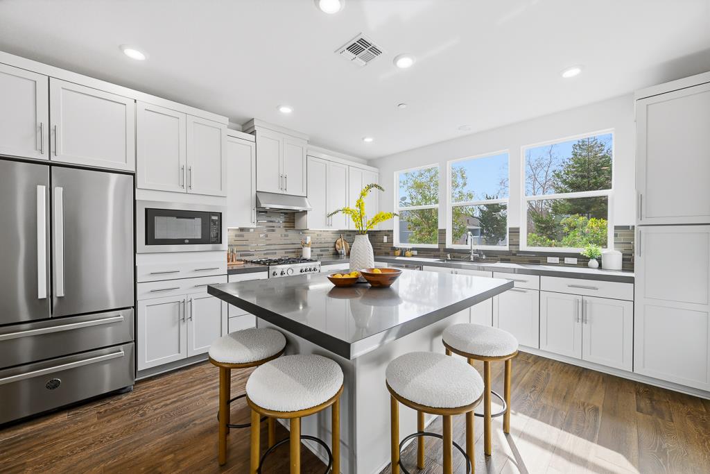 2287 Mora Place Mountain View, CA 94040 - Photo 14 of 64 a kitchen with stainless steel appliances granite countertop a sink a stove a refrigerator cabinets and dining table