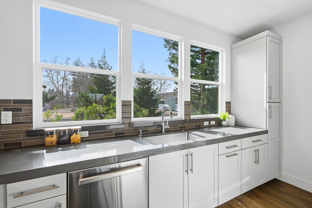 2287 Mora Place Mountain View, CA 94040 - Photo 18 of 64 a kitchen with stainless steel appliances white cabinets and a large window