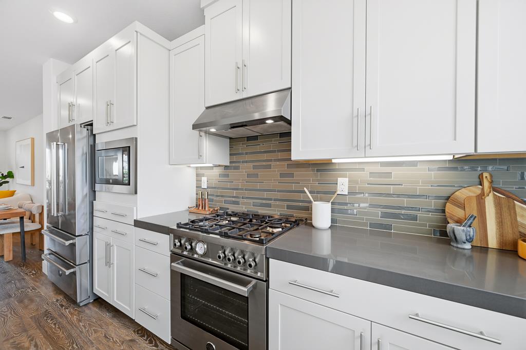 2287 Mora Place Mountain View, CA 94040 - Photo 20 of 64 a kitchen with stainless steel appliances granite countertop a refrigerator stove and white cabinets