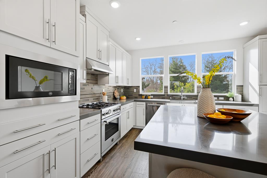 2287 Mora Place Mountain View, CA 94040 - Photo 21 of 64 a kitchen with stainless steel appliances granite countertop a sink a stove and a wooden floors