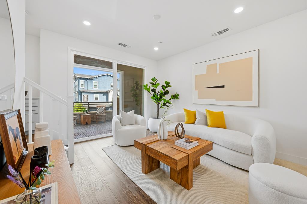 2287 Mora Place Mountain View, CA 94040 - Photo 3 of 64 a living room with furniture a bookshelf and a flat screen tv