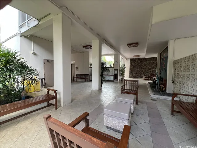 a living room with furniture and a potted plant